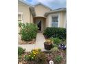 Inviting front entrance with a well-manicured garden, pathway, and a neutral-toned facade at 2672 Star Coral Ln, New Smyrna Beach, FL 32168