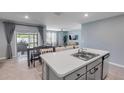 Bright, open kitchen with a view of the dining area and living room, featuring stainless steel appliances at 2731 Neverland Dr, New Smyrna Beach, FL 32168