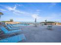 Enjoy the outdoor pool area with lounge chairs, tables, and beautiful ocean views at 3023 S Atlantic Ave # 8010, Daytona Beach, FL 32118