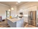 Bright kitchen featuring stainless steel appliances, granite counters, pendant lighting, and a functional island at 3027 Portofino Blvd, New Smyrna Beach, FL 32168