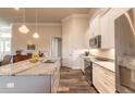 Well-equipped kitchen boasts stainless steel appliances, granite counters, and a spacious island with a sink at 3027 Portofino Blvd, New Smyrna Beach, FL 32168