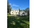 Spacious backyard with detached garage and siding home, perfect for outdoor activities at 306 Murray St, New Smyrna Beach, FL 32168