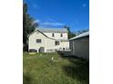 View of the back of the house and garage from the yard on a sunny day at 306 Murray St, New Smyrna Beach, FL 32168