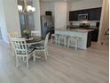 Charming dining and kitchen area with seating for three at the island at 3103 Nova Scotia Way, New Smyrna Beach, FL 32168