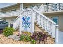 Condo entrance with beautiful landscaping and clear signage for 