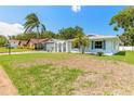 Lovely home featuring a lush green lawn, palm trees, and a freshly painted exterior at 3626 Donna St, Port Orange, FL 32129