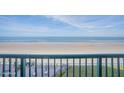 Relaxing ocean views from a private balcony with lounge chairs and a brick patio below at 4555 S Atlantic Ave # 4405, Ponce Inlet, FL 32127
