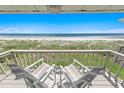 Relaxing oceanfront balcony featuring chairs and breathtaking views of the beach at 4777 S Atlantic Ave # B2, Port Orange, FL 32127