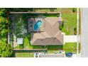 Aerial view of the property showcasing the pool, surrounding greenery, and defining property lines at 505 Sandale Ct, Deland, FL 32724