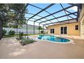 Screened-in pool with a spacious patio, perfect for outdoor relaxation and enjoying the landscaped backyard at 505 Sandale Ct, Deland, FL 32724