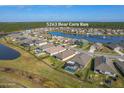An aerial view of the property showcases a pool and the tranquil lake views in the Hawks Preserve community at 5263 Bear Corn Run, Port Orange, FL 32128