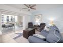Comfortable living room featuring stylish decor, plush seating, and access to a private balcony at 5300 S Atlantic Ave # 11302, New Smyrna Beach, FL 32169