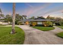 Beautiful home boasting lush lawn, mature trees, and a long winding driveway at 544 Bottlebrush Ct, New Smyrna Beach, FL 32168