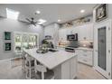 Bright, open kitchen featuring a large island, stainless appliances, and ample storage at 544 Bottlebrush Ct, New Smyrna Beach, FL 32168