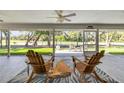 Relaxing screened lanai with comfortable seating overlooking a lush outdoor view at 544 Bottlebrush Ct, New Smyrna Beach, FL 32168