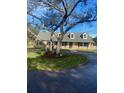 Charming single-Gathering home featuring dormer windows, a well-manicured lawn and mature trees at 5832 Michelle Ln, Sanford, FL 32771