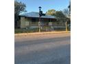 Charming single-story home with a quaint front porch and a landscaped front yard at 585 Washington St, New Smyrna Beach, FL 32168