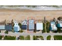 Aerial view of a beachfront property highlighting its proximity to the ocean and surrounding neighborhood at 6883 S Atlantic Ave, New Smyrna Beach, FL 32169