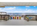 Ocean view from deck with colorful seating arrangements on a beautiful day with nice weather at 6883 S Atlantic Ave, New Smyrna Beach, FL 32169
