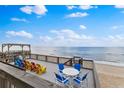 Expansive deck featuring colorful seating, and breathtaking ocean views perfect for outdoor relaxation at 6883 S Atlantic Ave, New Smyrna Beach, FL 32169