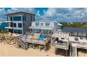 Beachfront home with a spacious deck featuring colorful seating and ocean views at 6883 S Atlantic Ave, New Smyrna Beach, FL 32169