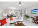 Inviting living room with a modern ceiling fan, stylish decor, and an open layout to the kitchen at 7 Riverwalk Dr # 305, New Smyrna Beach, FL 32169