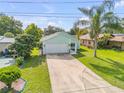 Beautiful home boasting lush green lawn, extended driveway, and well-maintained landscaping at 805 Spruce St, New Smyrna Beach, FL 32168