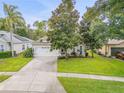 Charming single-story home with a well-maintained lawn, beautiful trees, and a two-car garage at 850 Wingate Trl, Port Orange, FL 32128