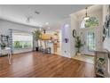 Bright living room with hardwood floors, large windows, and an open view into the kitchen at 850 Wingate Trl, Port Orange, FL 32128