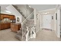 Warm foyer with stairs, neutral tones, and view of the kitchen at 901 S Atlantic Ave # 202, Ormond Beach, FL 32176