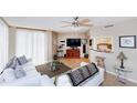 Cozy living room features a ceiling fan, comfortable seating, stylish decor, and a pass through to the kitchen at 1 Oceans West Blvd # 1B5, Daytona Beach, FL 32118