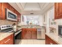 Modern kitchen with stainless steel appliances, granite countertops, and ample cabinet space at 1237 Charter Oaks Cir, Daytona Beach, FL 32117