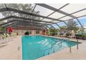 Community pool with ample seating and a covered enclosure at 1237 Charter Oaks Cir, Daytona Beach, FL 32117