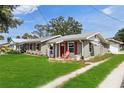Charming exterior view highlighting the well-maintained lawn and cozy curb appeal of the home at 132 E Turgot Ave, Edgewater, FL 32132