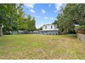 Two-story home featuring gray and white exterior with a lush green lawn at 2005 Sunny Ln, New Smyrna Beach, FL 32168
