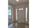 Foyer with tile flooring, a front door with decorative glass, and side lights at 2029 Willow Oak Dr, Edgewater, FL 32141