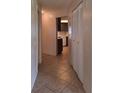 Hallway with tile flooring and a view into the kitchen at 2029 Willow Oak Dr, Edgewater, FL 32141