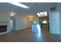 Open-concept living space with wood floors, connecting the living room, dining area, and kitchen at 2548 Crestwood Ave, New Smyrna Beach, FL 32168