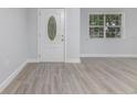 Bright entryway featuring stylish flooring, a modern door, and ample natural light at 2617 Pine Tree Dr, Edgewater, FL 32141