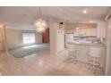 Open-concept kitchen with white cabinetry, stainless appliances, and breakfast bar seating at 2944 Mango Tree Dr, Edgewater, FL 32141