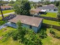 An aerial view of a single-story home with a spacious yard and covered carport at 3045 Pine Tree Dr, Edgewater, FL 32141