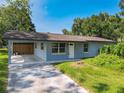 Charming single-story home with a covered carport and tidy front yard at 3045 Pine Tree Dr, Edgewater, FL 32141