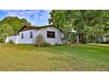 Charming white single-story home with mature trees and well-maintained lawn in a desirable location at 314 Carol Ann Dr, Edgewater, FL 32132