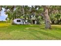 Quaint single-story home with stucco exterior, mature trees, and well-maintained lawn at 314 Carol Ann Dr, Edgewater, FL 32132