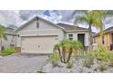 Well-maintained home boasts a two-car garage, neatly landscaped front yard with attractive curb appeal at 349 Caryota Ct, New Smyrna Beach, FL 32168
