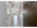 Hallway view of condo #406 featuring light gray floors and partial views of the Living Room at 3606 S Peninsula Dr # 406, Port Orange, FL 32127