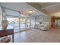 Light and bright lobby with neutral tile floors, contemporary furnishings, and secured entry at 3606 S Peninsula Dr # 406, Port Orange, FL 32127