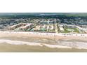 Stunning aerial view showcasing the pristine beach, beachfront condo and hotels plus nearby restaurants and entertainment at 3700 S Atlantic Ave # 108, New Smyrna Beach, FL 32169