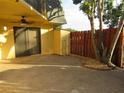 Exterior view of the property featuring a secure side entry and storage closet, with a decorative rock garden at 3824 Saxon Dr, New Smyrna Beach, FL 32169