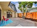 Private patio area featuring a wooden fence, exterior storage, and a cozy seating area at 3824 Saxon Dr, New Smyrna Beach, FL 32169